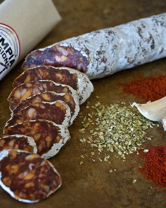 Salami Chorizo with garlic and pepper on wooden background