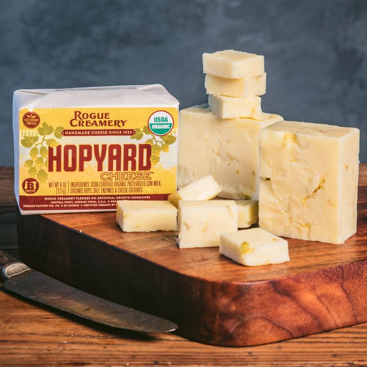 Organic Hopyard cheddar on cutting board with knife
