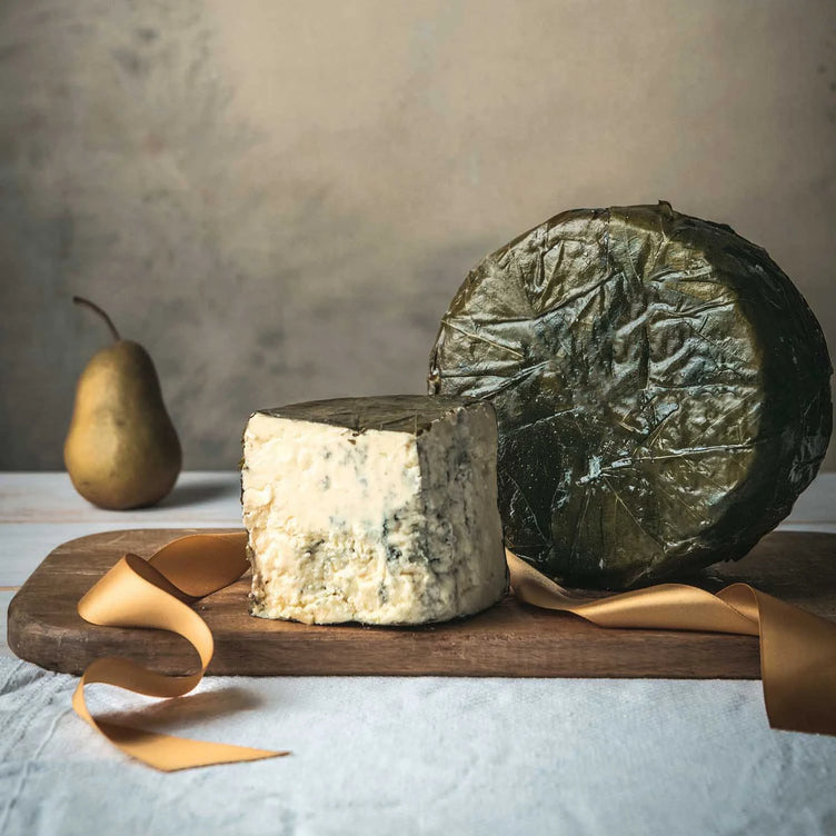 Organic Rogue River Blue Whole Wheel and wedge on cutting board