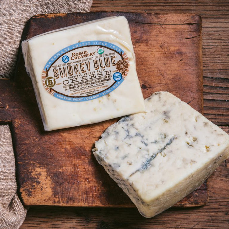 Wedges of organic smokey blue cheese on a cutting board