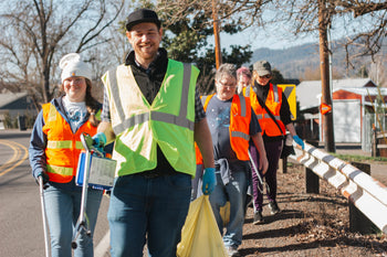 Rogue Creamery Team picking up trash with safety vests