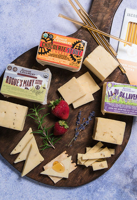 Organic cheeses with rosemary, lavender, and honey on a cutting board