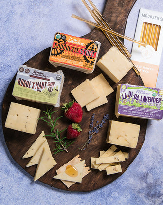 Organic cheeses with rosemary, lavender, and honey on a cutting board