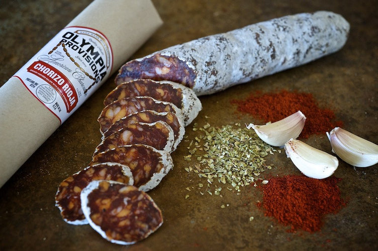 Salami Chorizo with garlic and pepper on wooden background