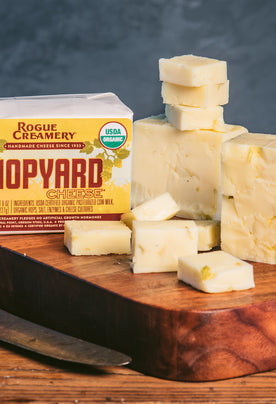 Organic Hopyard cheddar on cutting board with knife