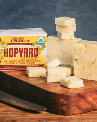 Organic Hopyard cheddar on cutting board with knife