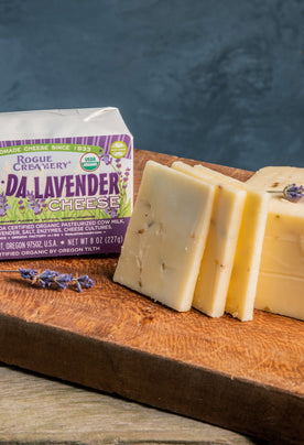 Organic Lavender Cheese on cutting board with leaves of lavendar