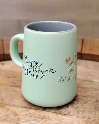 Mint colored mug on wooden cutting board