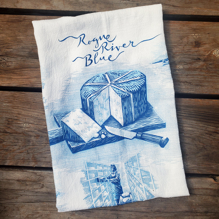 Rogue River Blue Tea Towel on wooden cutting board