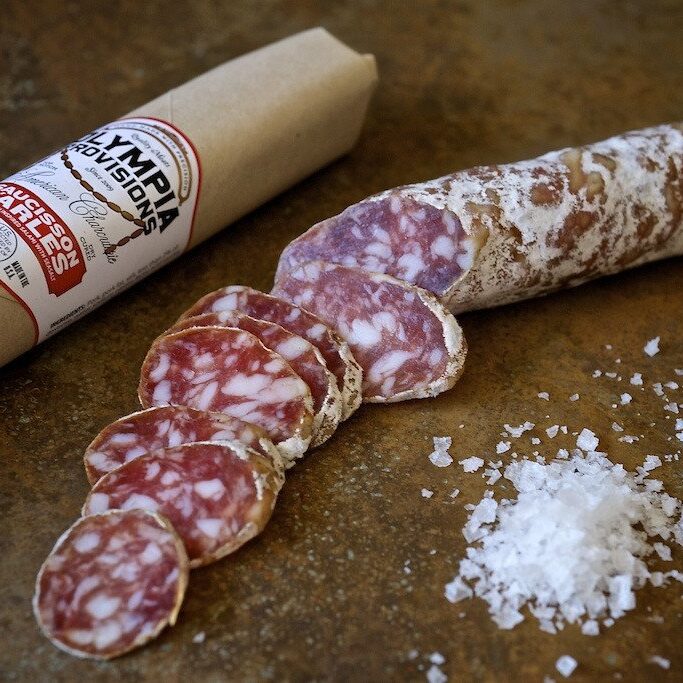 Salami on cutting board with a pile of salt