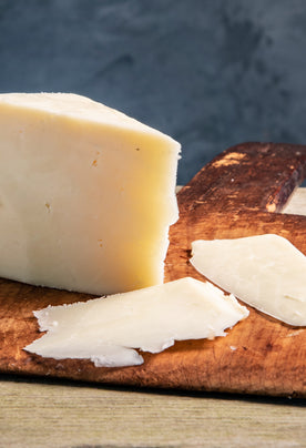 Organic Touvelle Cheese on cutting board with cheese slices