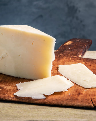 Organic Touvelle Cheese on cutting board with cheese slices