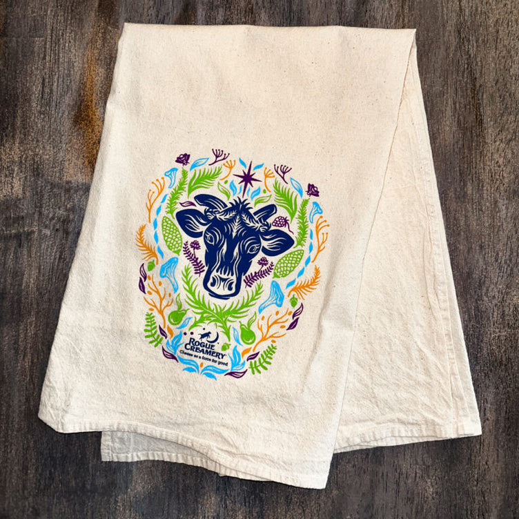 Floral cow print on tea towel on wooden background