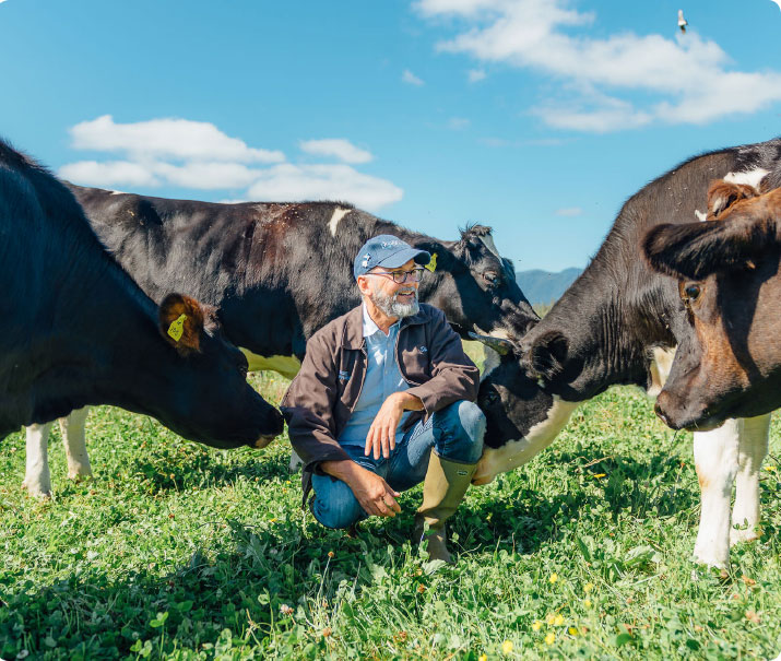 David Gremmels Rogue Creamery Founder in a field with organic dairy cows