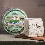 Rogue Creamery Organic Raw Oregonzola Blue Cheese next to whole wheel
