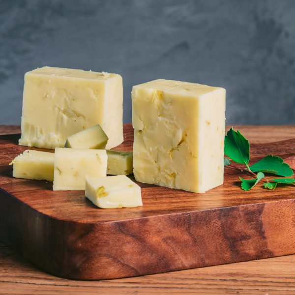 Rogue Creamery Organic Hopyard Cheddar block on cheese board