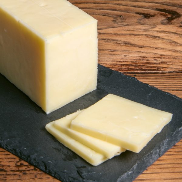Rogue Creamery Jefferson 1 Year aged cheddar slices on cutting board