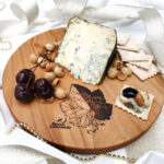 Rogue River Blue Cutting Board with Cherries, Hazelnuts, crackers, and blue cheese