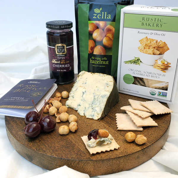 Rogue River Blue Deluxe Upgrade Pack contents containing crackers, hazelnuts, tasting book, and cherries