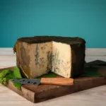 Rogue River Blue Cheese Whole Wheel with wedge cut out showing blue veins